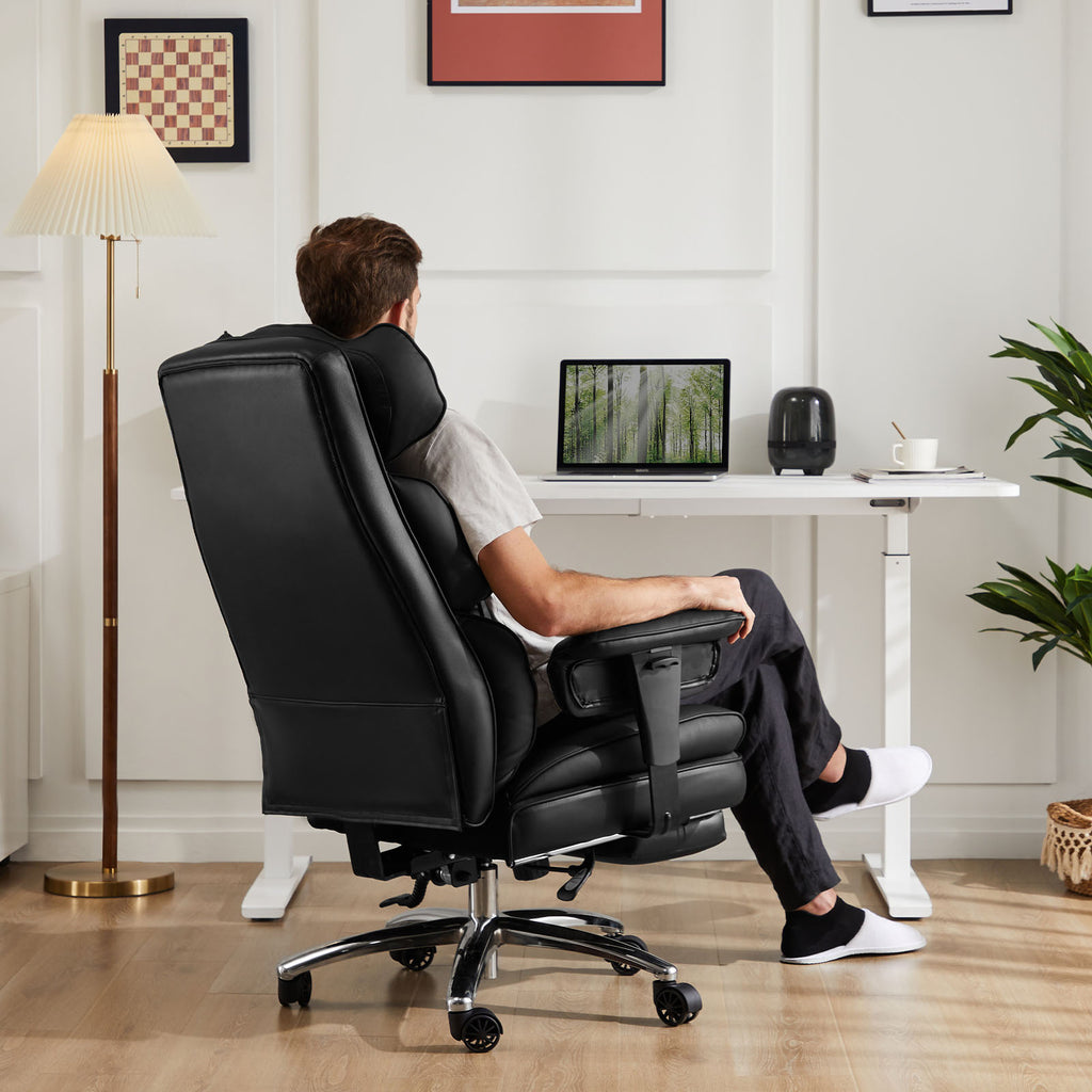 Person using a black office chair in a home office setting with a desk and laptop.