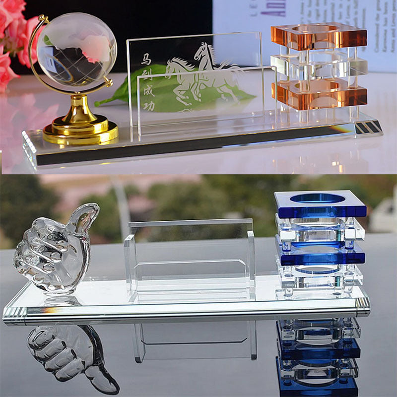 Collection of decorative crystal items on a reflective surface with blurred background