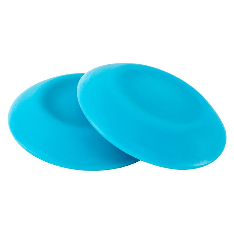 Two blue silicone coasters on a white background