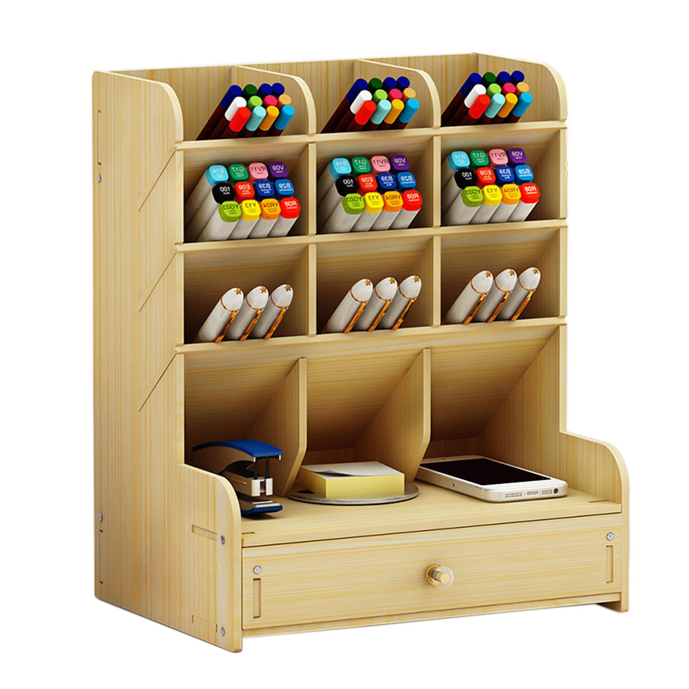 Wooden desk organizer with shelves and a drawer containing markers, pens, and office supplies on a white background.