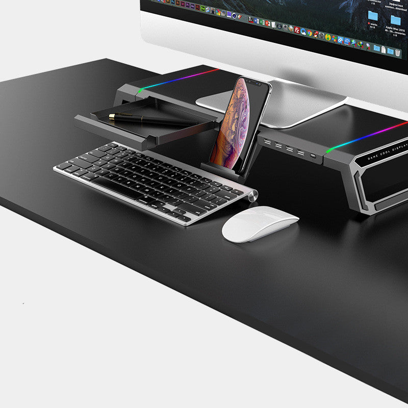 Black desk with computer setup including keyboard, mouse, and monitor on a white background