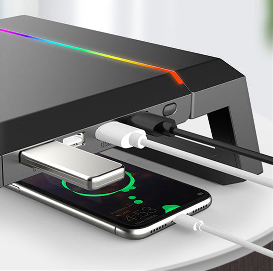 Multifunctional charging station with smartphone, wireless earbuds, and power bank on a white surface.