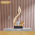Decorative golden sculpture with measurements on a plain background