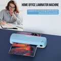 Home office laminator machine with a woman using a laptop in the background