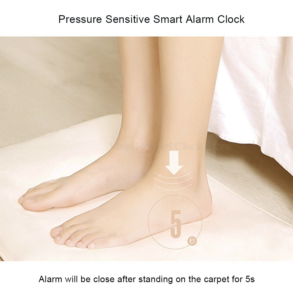 Pressure sensitive smart alarm clock with feet on a carpet