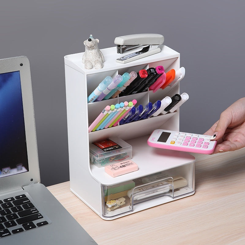 White desk organizer with stationery items on a desk next to a laptop.