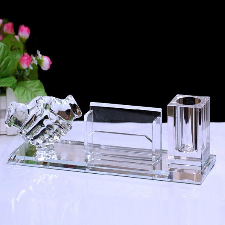 Crystal desk set with a candle holder, business card holder, and pen holder on a white surface.