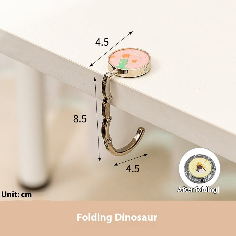 Folding dinosaur keychain with measurements on a white background