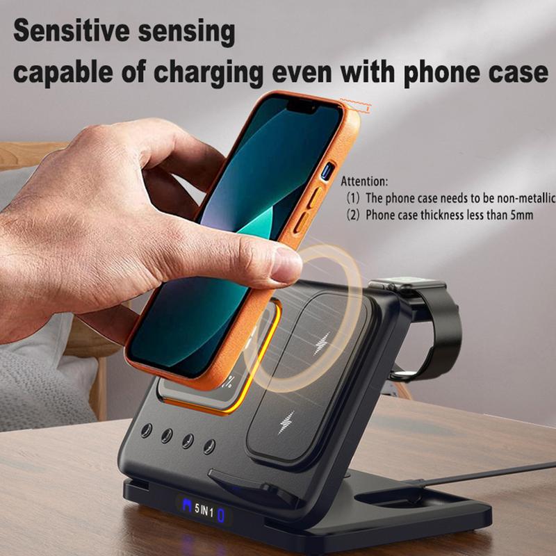 Hand holding a smartphone with an orange case over a wireless charging stand.