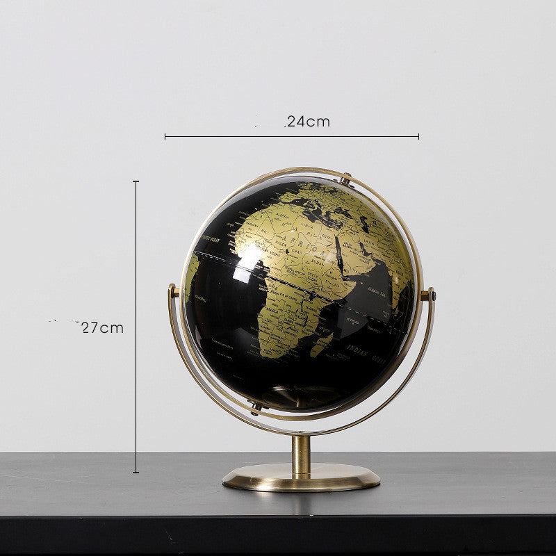 Black and gold globe with measurements on a gray background