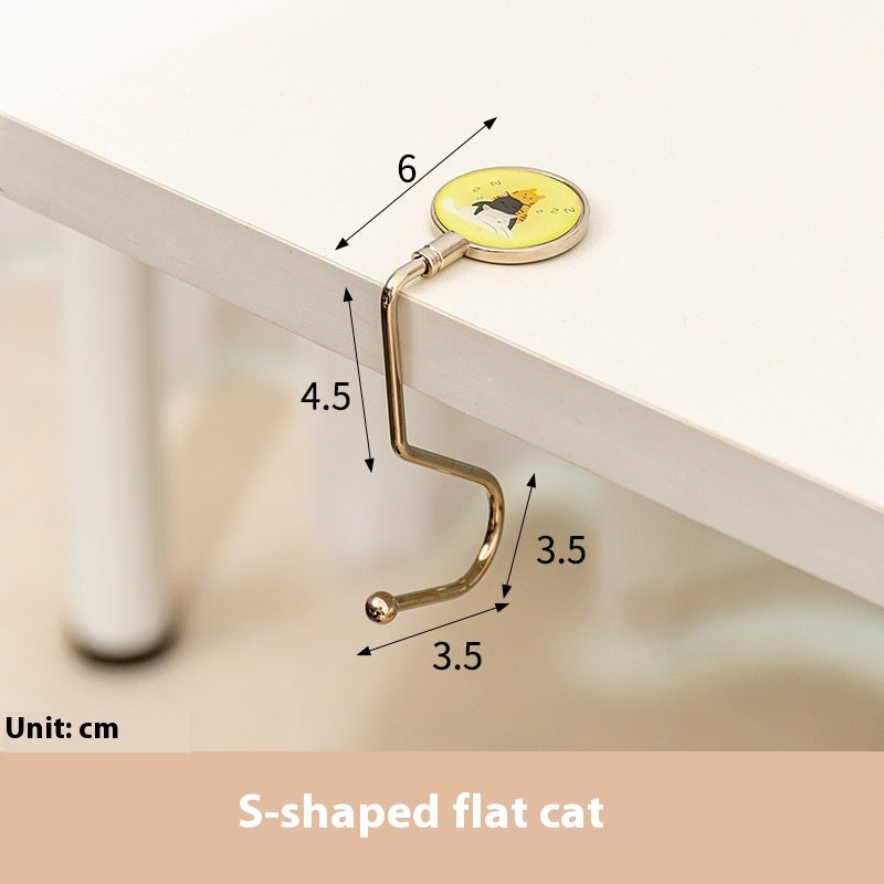 Measurement of a gold hook on a white surface with dimensions indicated.
