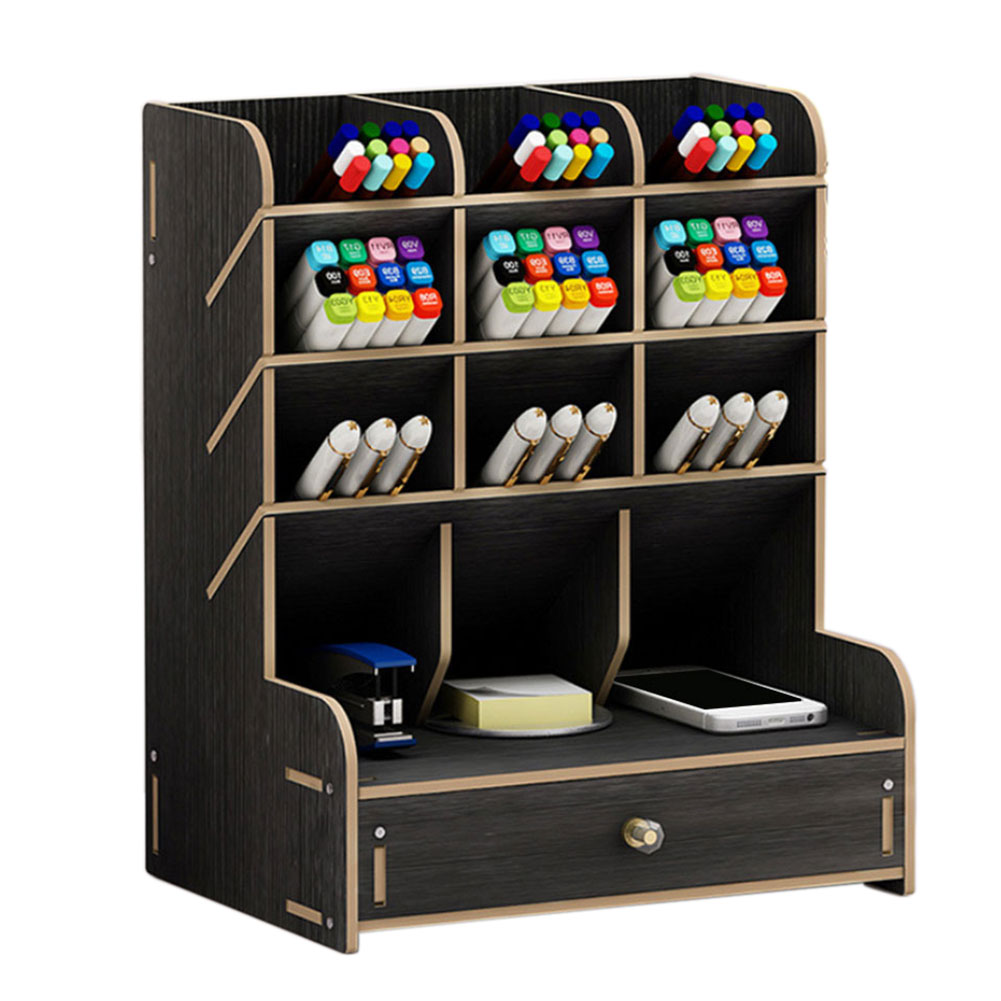 Wooden desk organizer with markers, pens, and a phone on a white background