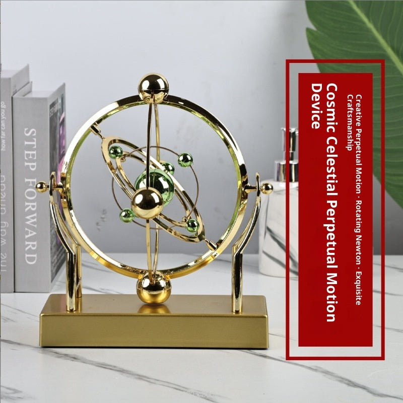 Gold celestial model on a marble surface with a red text box