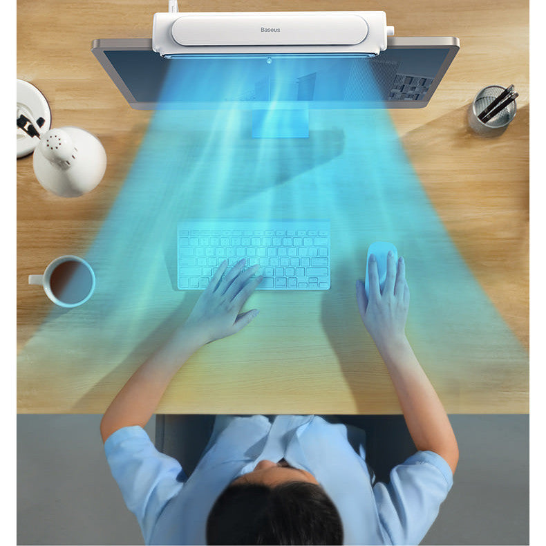 Person using a futuristic desk with a transparent keyboard projected onto a wooden surface.