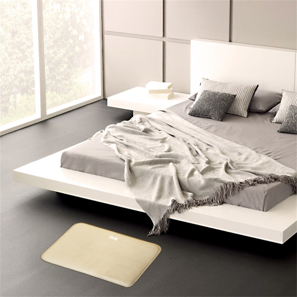 Modern bedroom with a bed and beige bath mat.