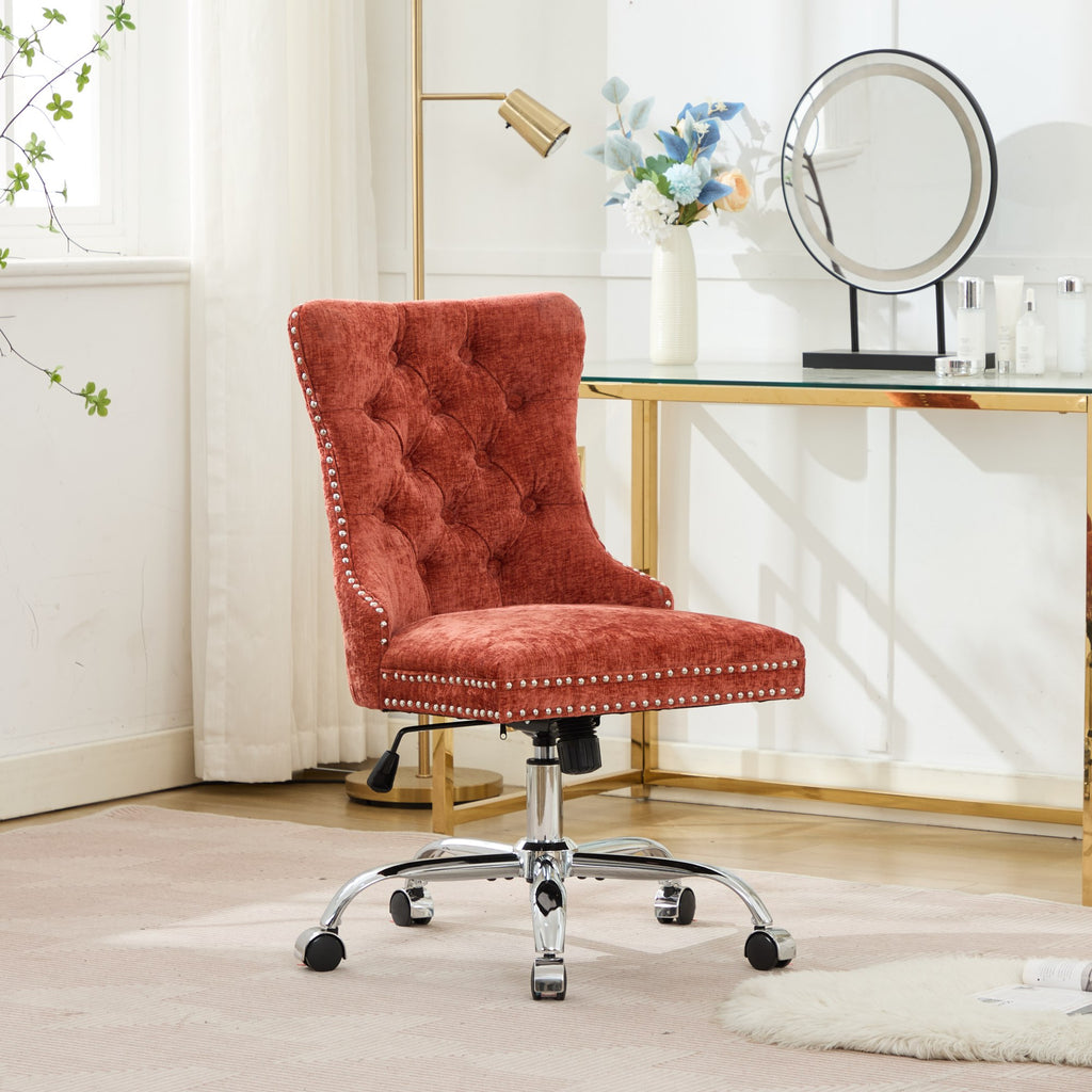Orange office chair with tufted backrest and chrome base on a white background
