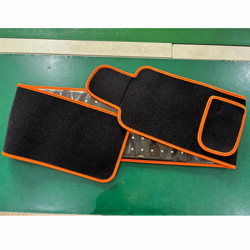 Black car mats with orange trim on a green surface