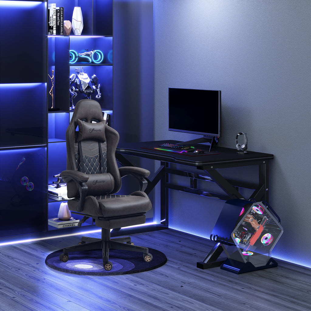 Gaming setup with chair, desk, and computer equipment in a room with blue lighting.