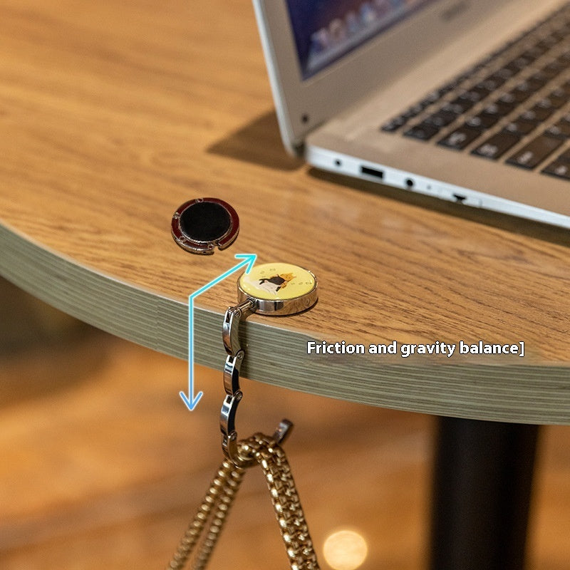 Desk with a keychain holder attached, showing friction and gravity balance.