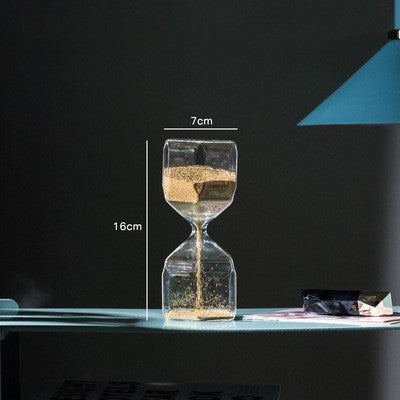 Glass hourglass with measurements on a dark background