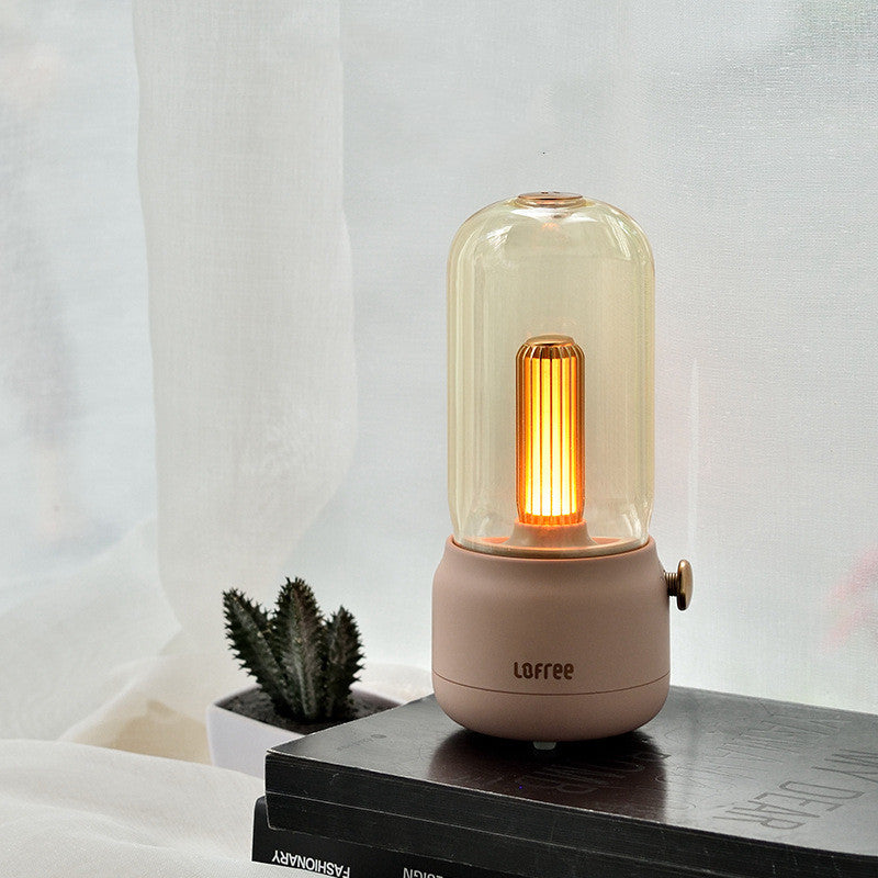 Decorative lamp with a glass cover and pink base on a surface with a white curtain background