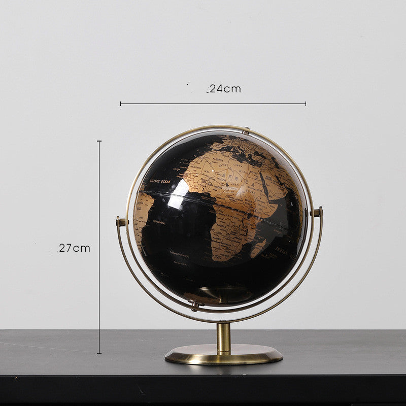 Black and gold globe with measurements on a gray background