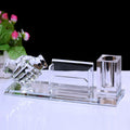 Crystal desk set with a candle holder, business card holder, and pen holder on a white surface.