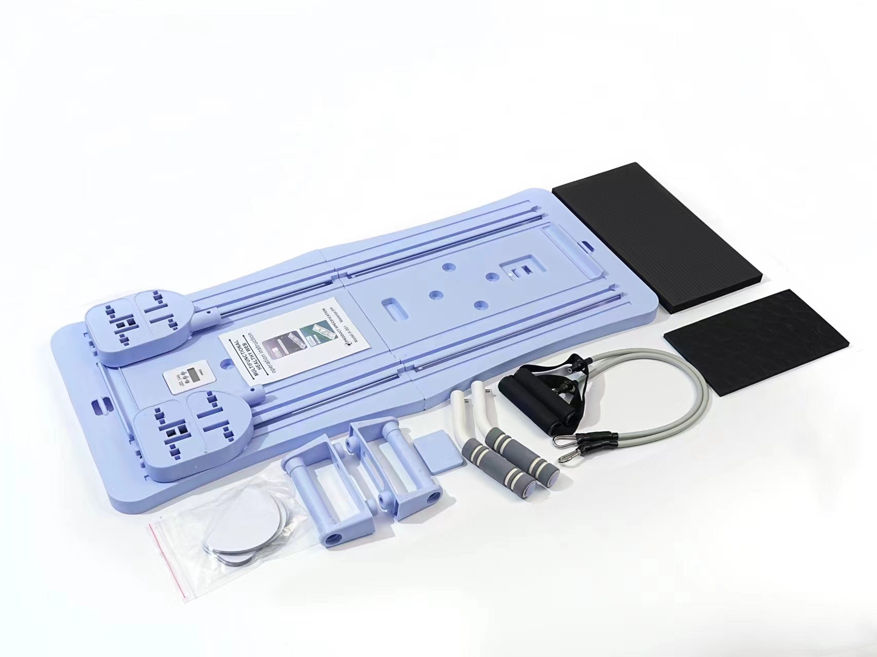 Collection of exercise equipment including a flat mat, resistance bands, and other fitness tools on a white background.