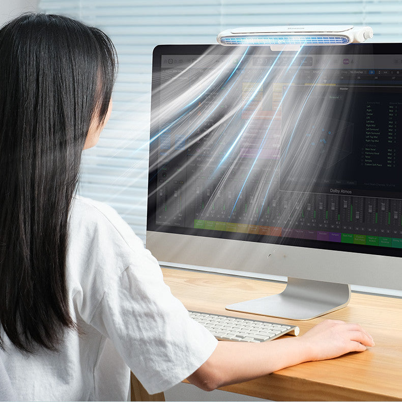 Person using a computer with a screen protector on a desk.