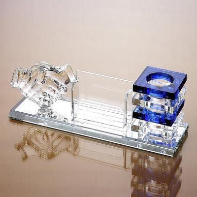 Crystal desk set with blue and clear elements on a reflective surface