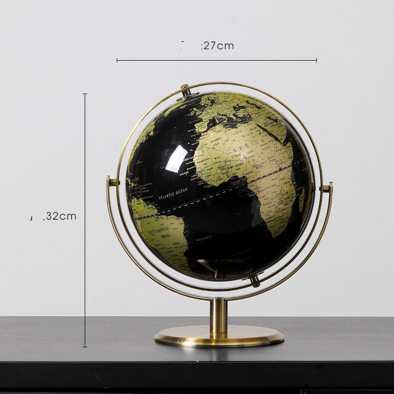 World globe with gold frame and black and gold map on a white background