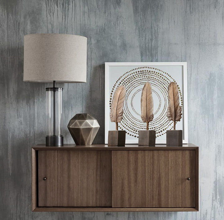 Wooden sideboard with decorative items against a gray textured wall