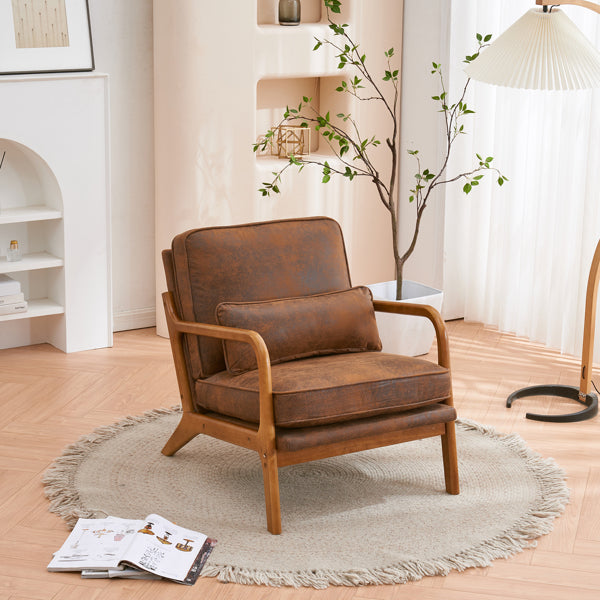 Brown leather armchair in a living room setting with a rug and books.