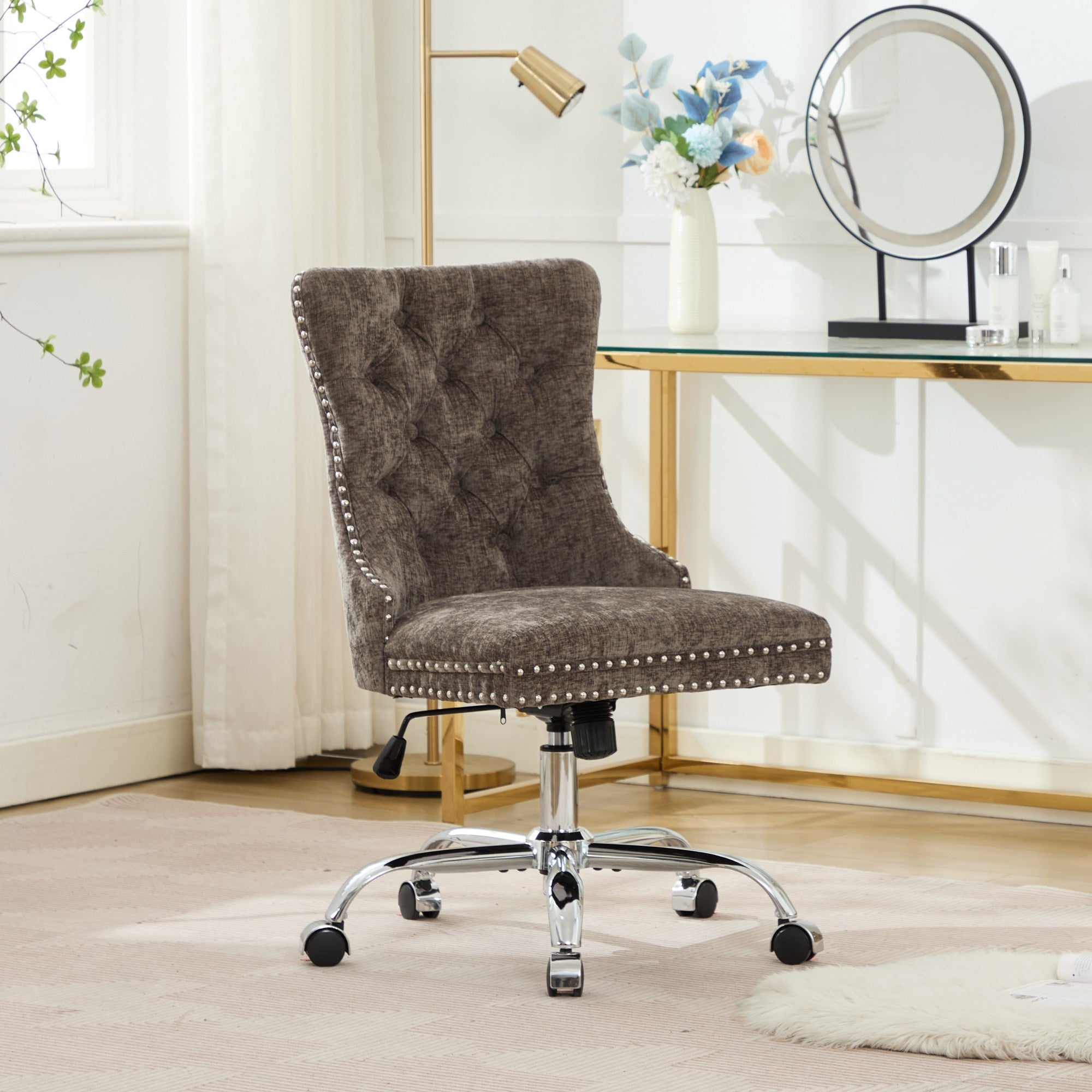 Brown office chair with chrome base in a room with a desk and decor items.