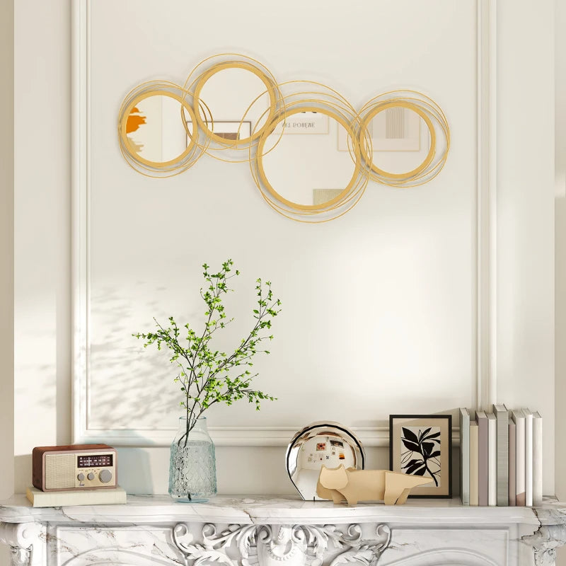 Decorative wall mirror with gold circular design above a white console table.