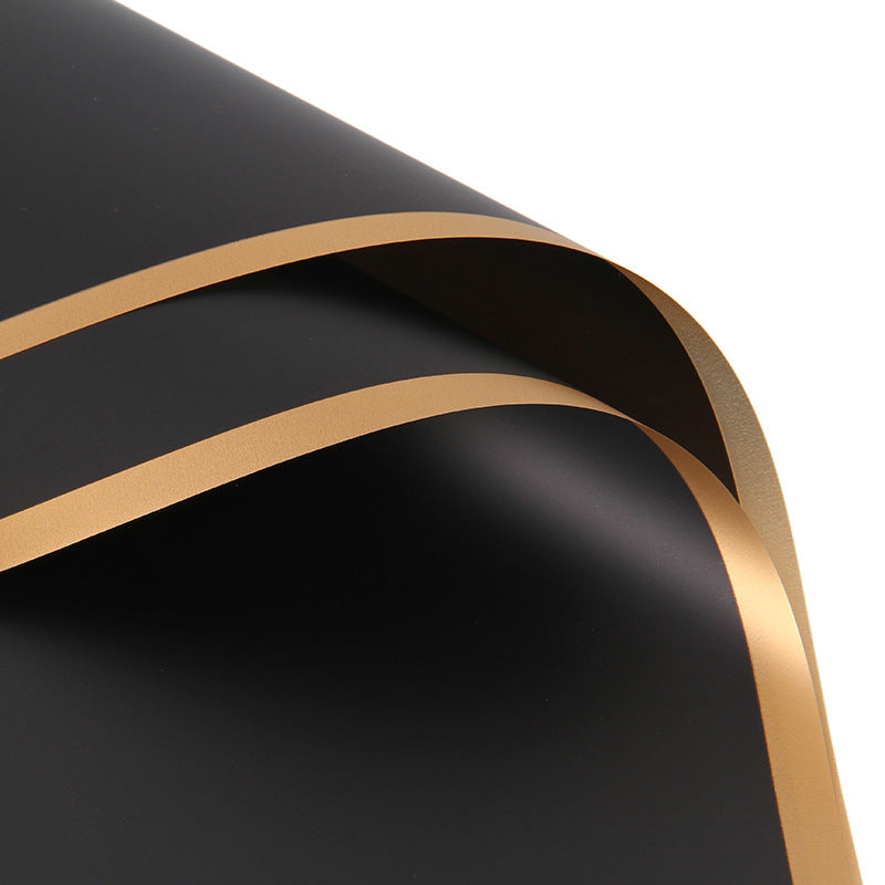 Black material with gold edges on a white background
