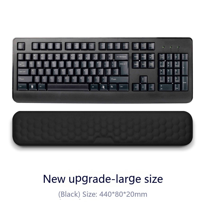 Black keyboard with wrist rest on a white background