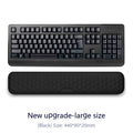Black keyboard with wrist rest on a white background