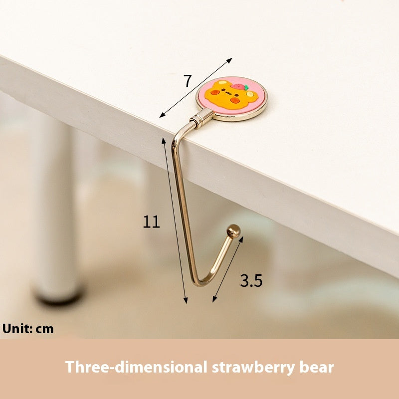 Three-dimensional strawberry bear hook with measurements on a white surface