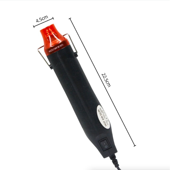 Black and red hot air gun with measurements on a white background