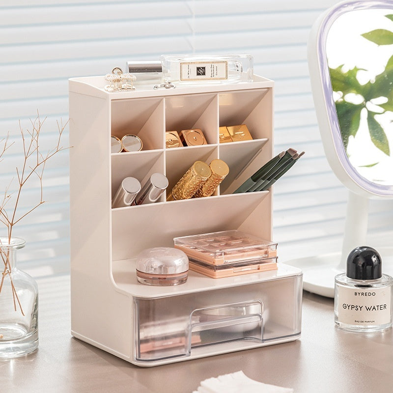 Beige cosmetic organizer with various items on a desk next to a Byredo perfume bottle.